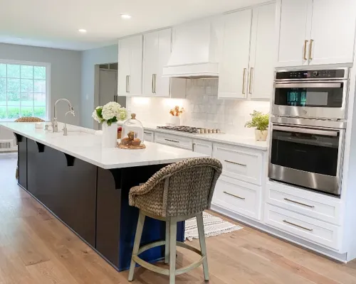 White kitchen featuring new wood floors and new cabinets.