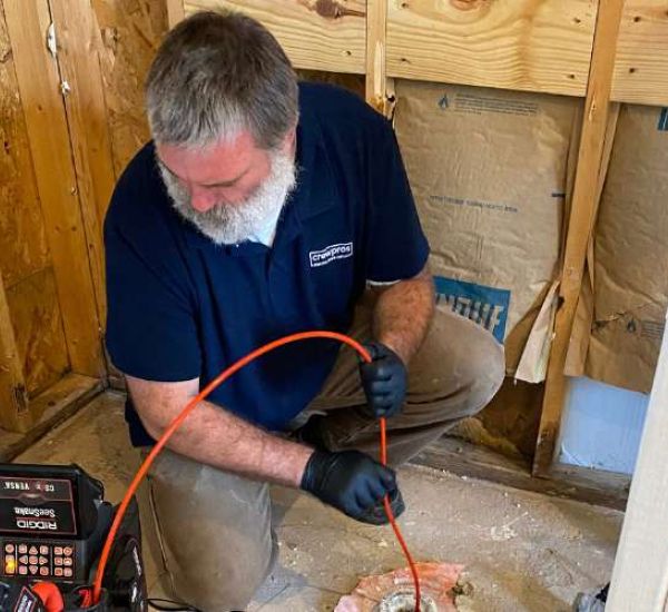 CrewPros employee performing a drain cam inspection.